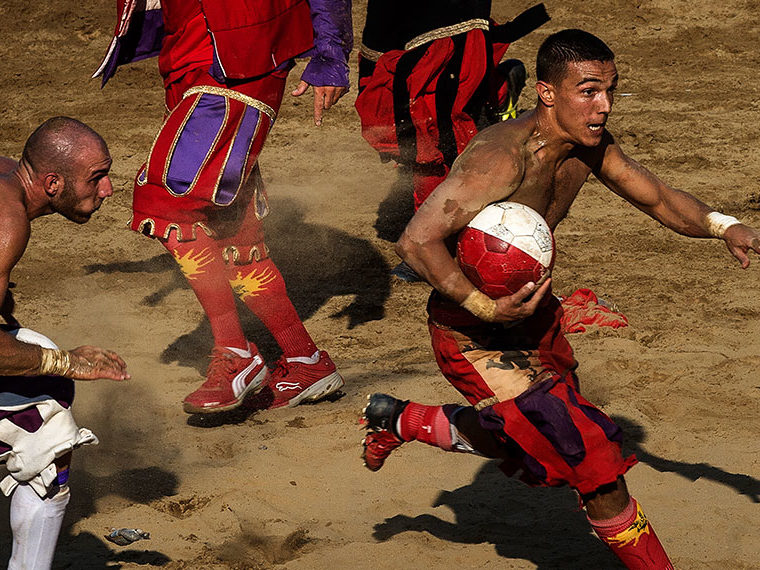 Man carrying a ball, playing indigenous sports