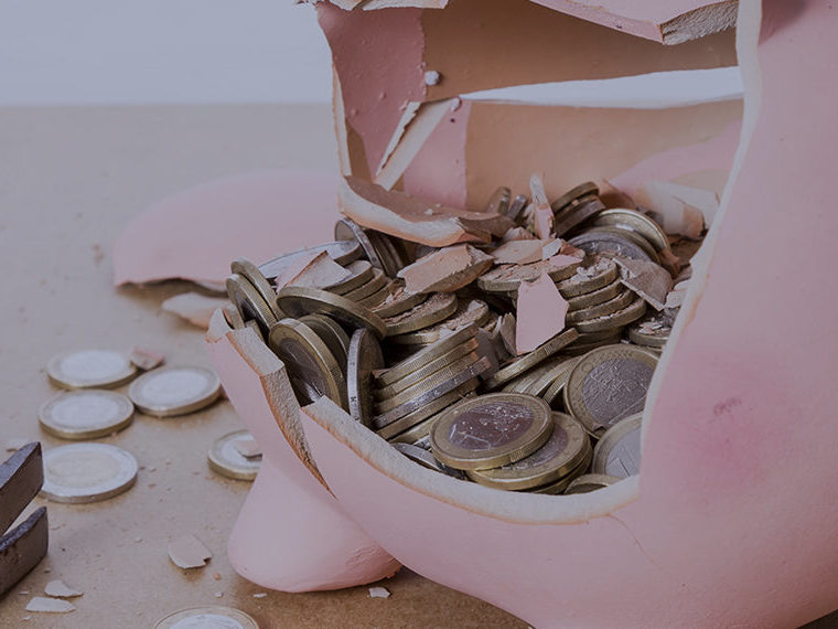 Broken piggy bank full of coins