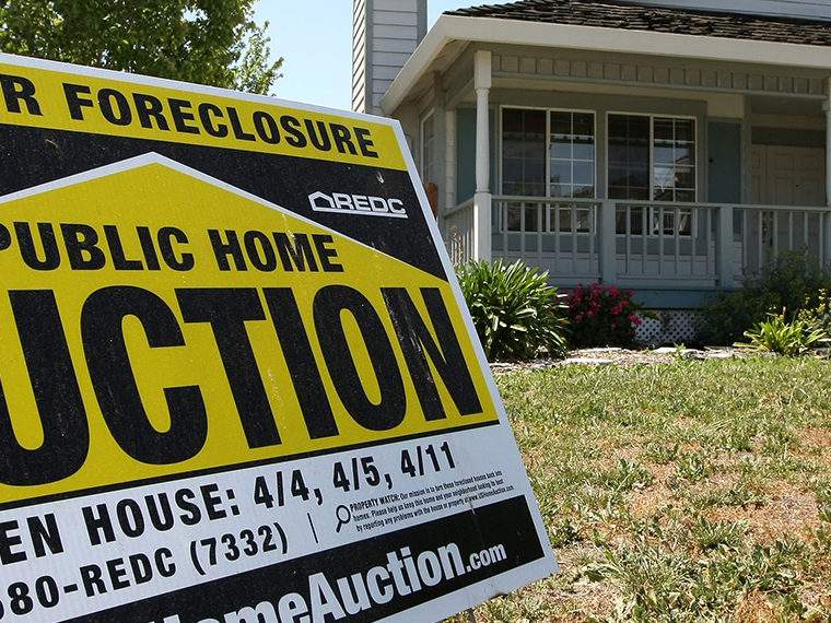 Home with an auction sign on the lawn