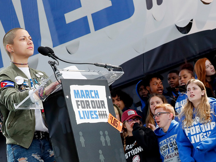 Emma Gonzalez speaking a podium for a March For Our Lives event