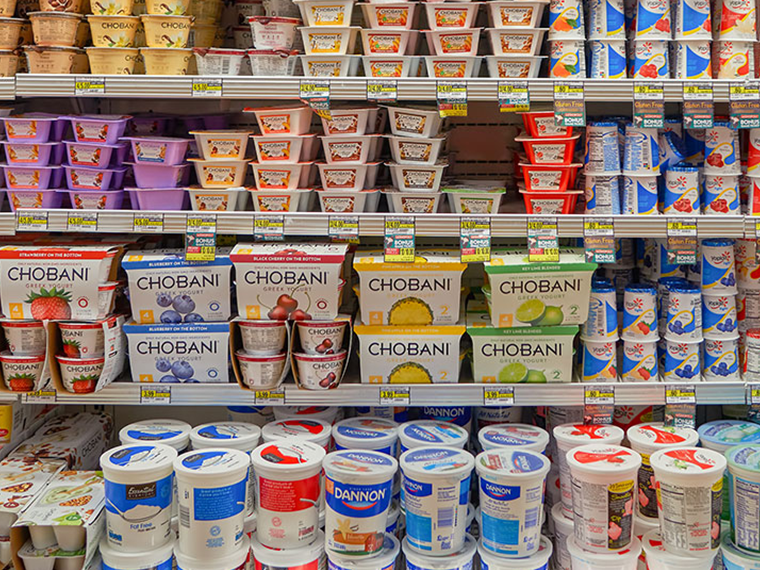 A full stocked grocery store yogurt section