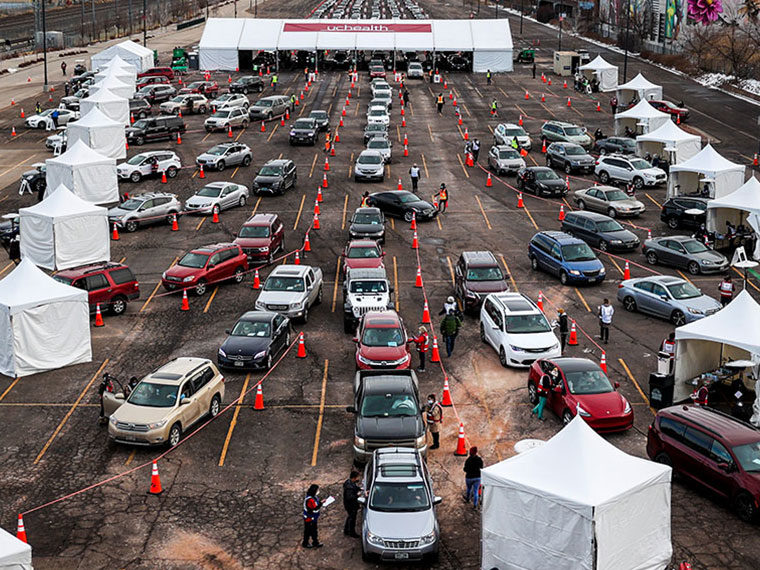 An overhead view of cars waiting in line for vaccine distribution