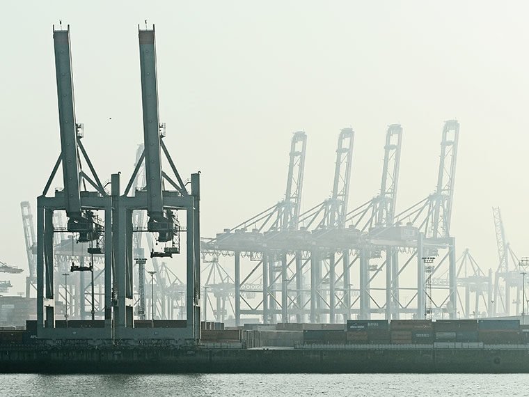Rows of gantry cranes at a harbor on a hazy day