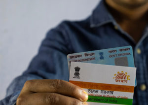 A close-up of Aadhaar card held in a man's hand