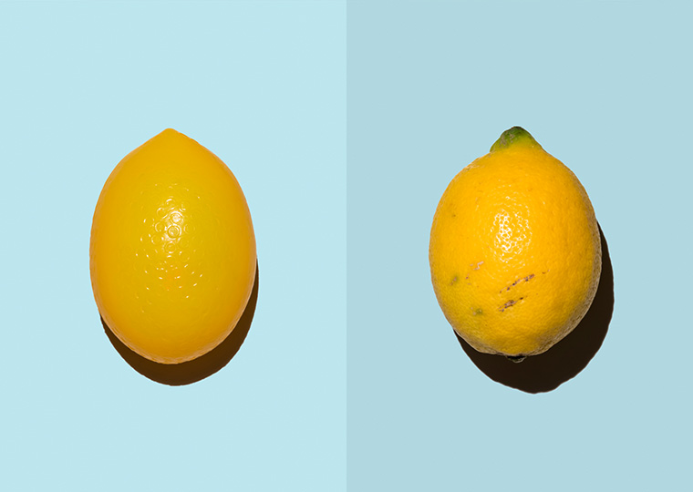 Split screen of fake lemon on the left and real lemon on the right.