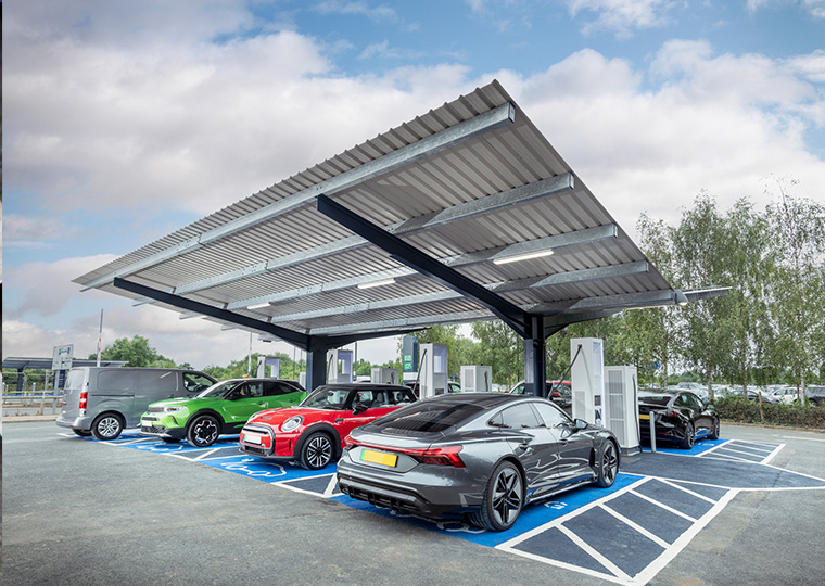 An electric charging station filled 2ith cars