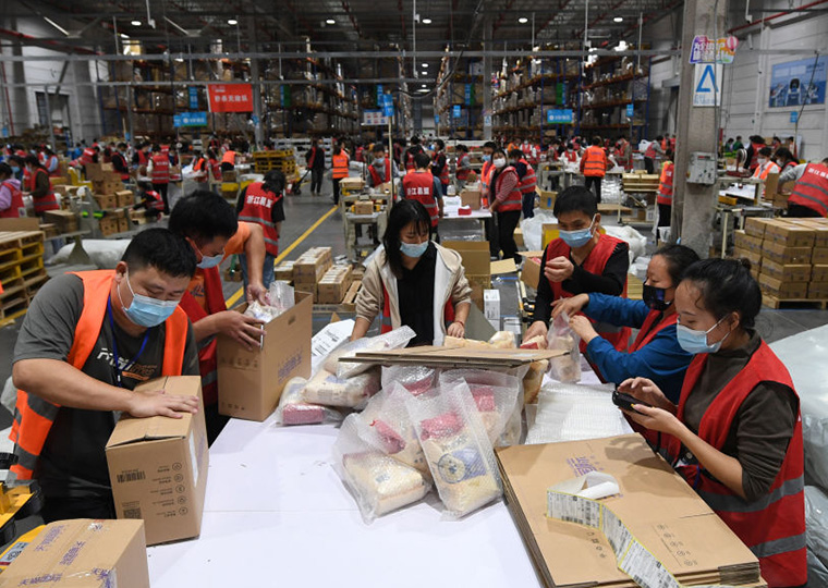Workers in a warehouse putting together packages