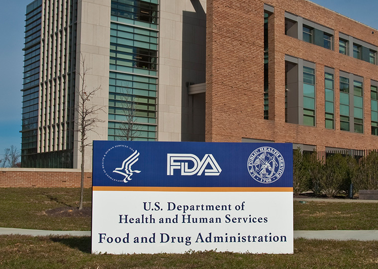 A blue and white sign in front of a building that reads: FDA U.S. Department of Health and Human Services Food and Drug Administration