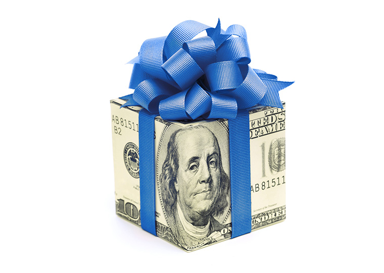 A cube of hundred dollar bills wrapped in a blue bow