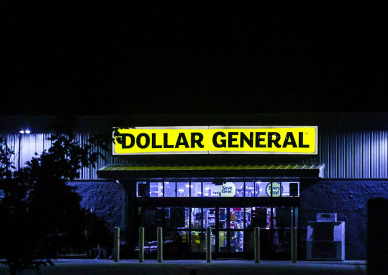An exterior night shot of a Dollar General store.