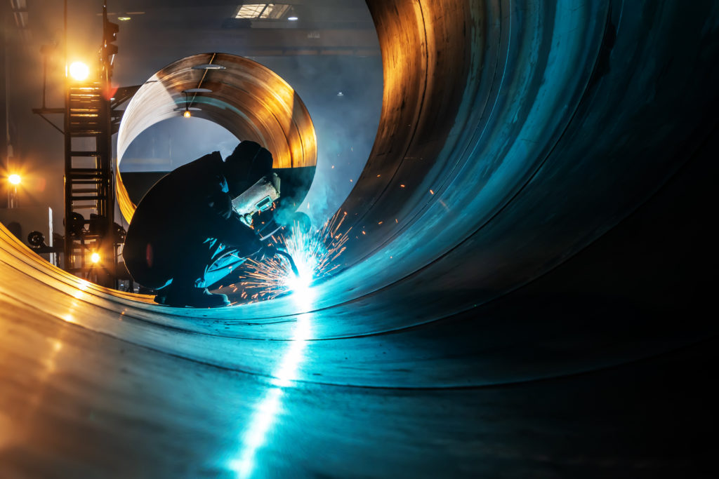 A welder is welding steel plates