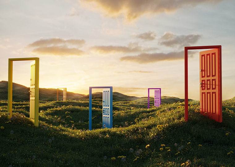 Five open doors in various colors on a hilly grass expanse.