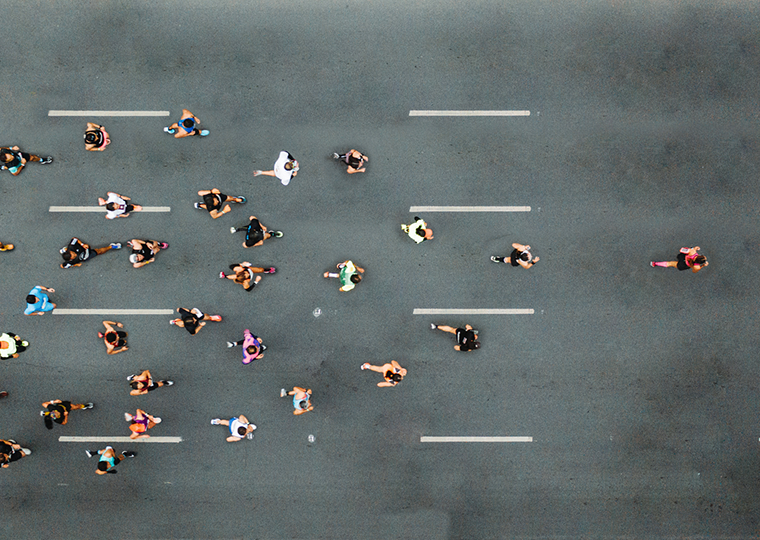 Aerial view of marathon city runners. One person leading marathon.