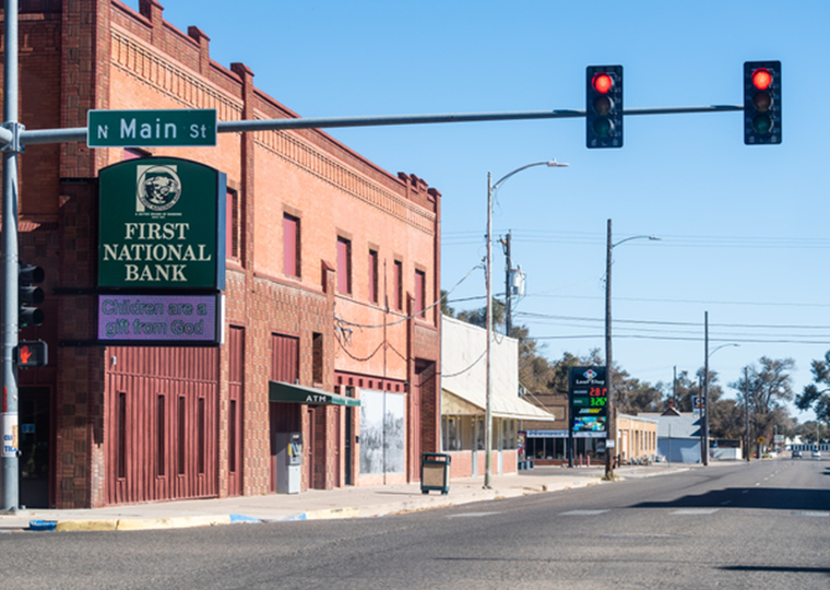 Small town in Colorado with red light on main street downtown and first national bank.