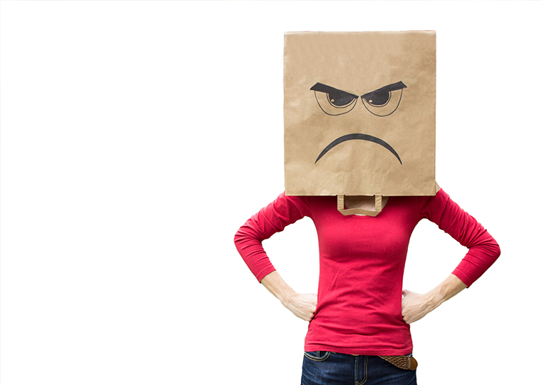 Woman in red shirt with brown paper bag on her head with an angry expression on it