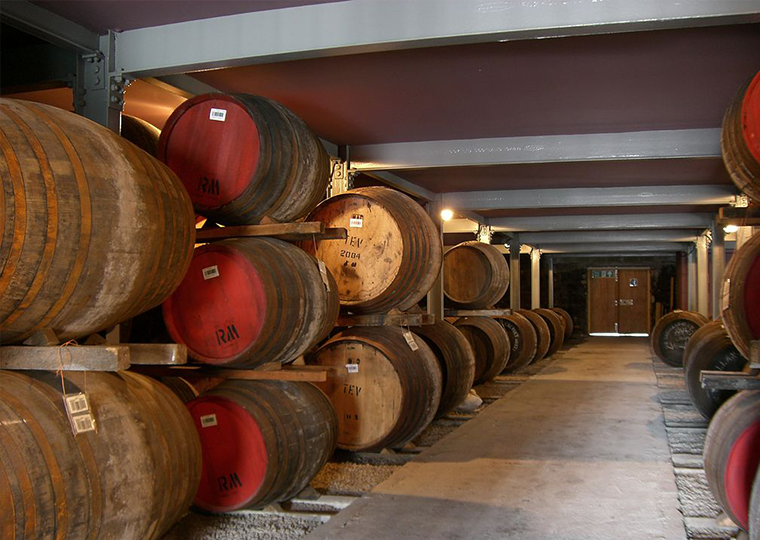 Scotch barrels stacked inside a distillery