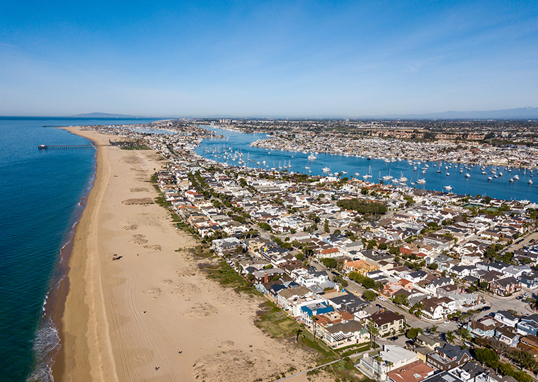 Aerial view of Newport Beach California with ocean and waterways.