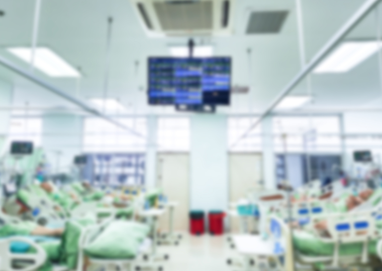 Blurred image of patients on hospital beds in ICU