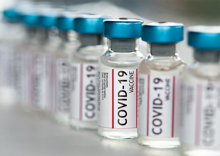 Covid-19 vaccine vials in a row macro close-up.