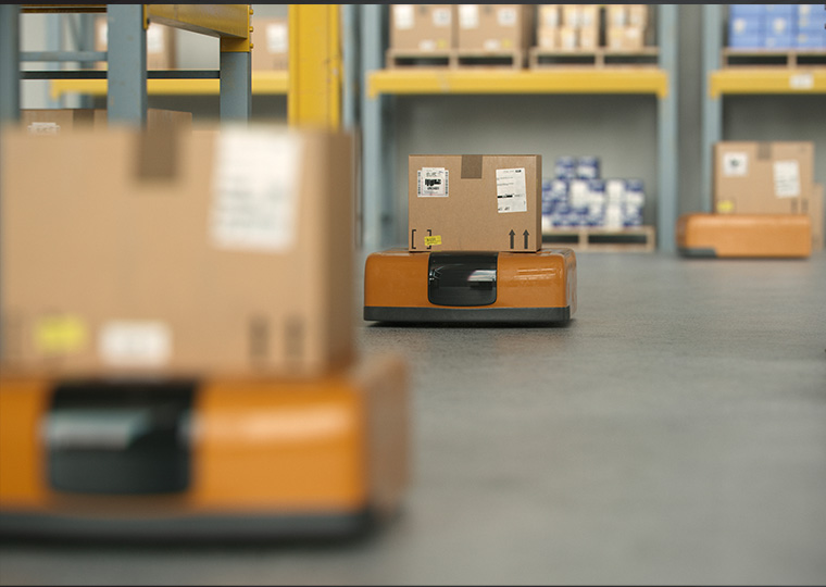 AI operated robots working in warehouse moving customer packages for delivery.