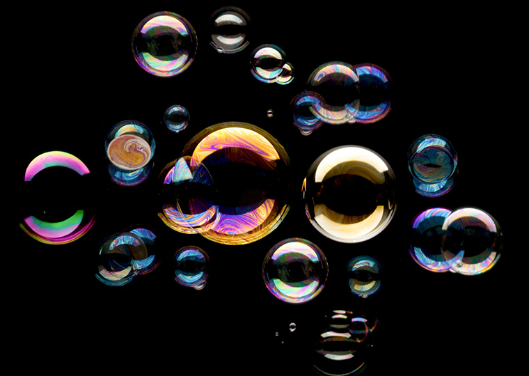 Multicolored soap bubbles on a black background.