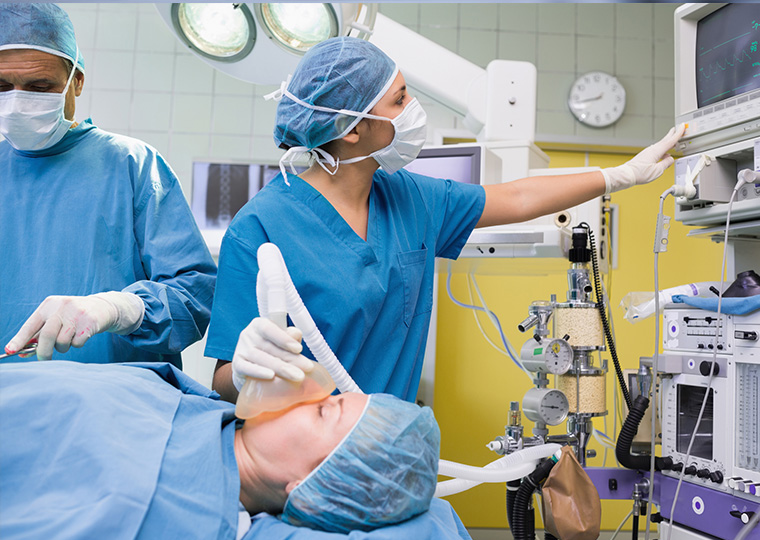 Anesthetist checking the ECG machine during an operation in a hospital