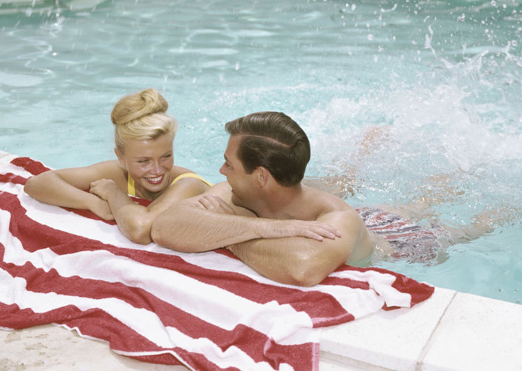 Young couple playing in swimming pool