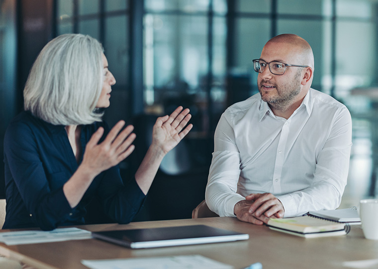 A woman and a man having a meeting.