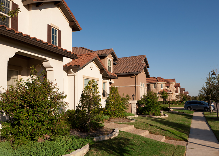 A line of houses on a street in an affluent neighborhood in Las Colinas, a suburb of Dallas