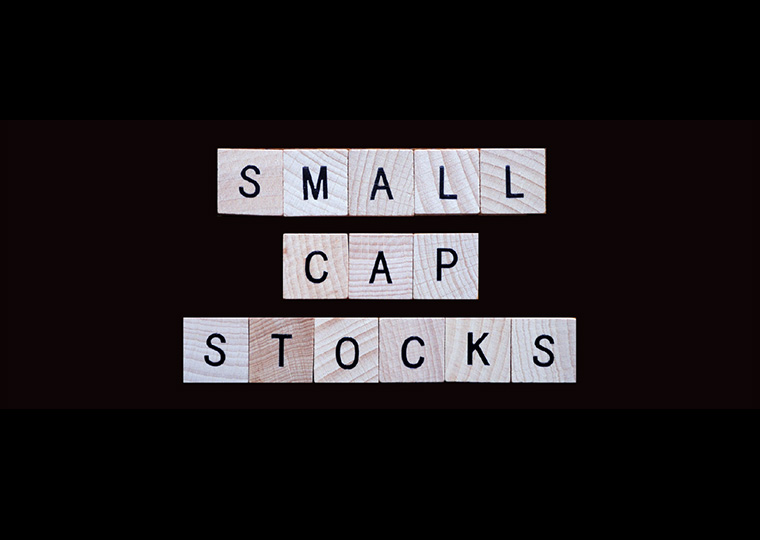 Small cap stocks in scrabble letters on black background