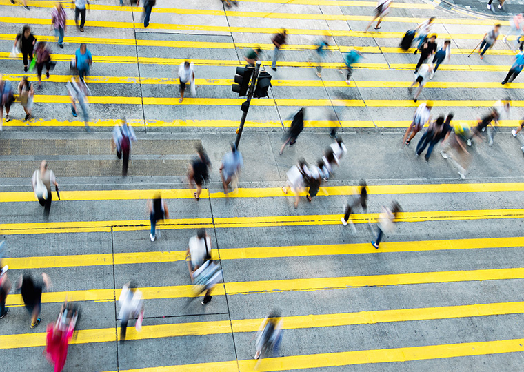 Aerial view of rush hour in city crosswalk.