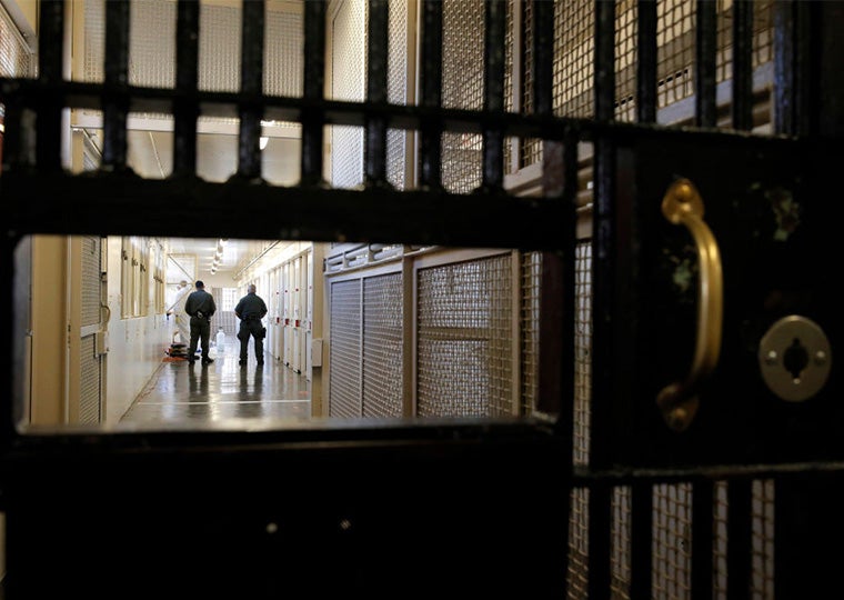 Two guards walking inside San Quentin State Prison.