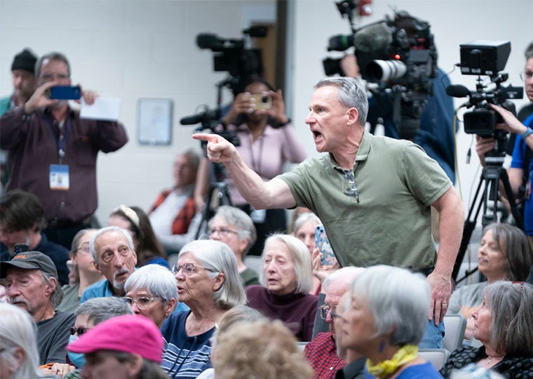 A man shouts during a congressional town hall meeting on March 13, 2025 in Asheville, North Carolina.
