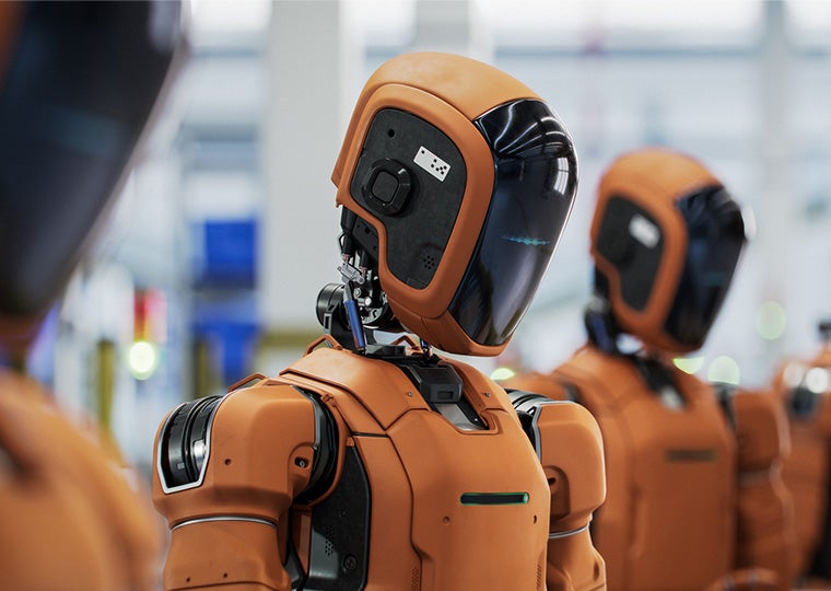 Orange AI-enabled autonomous humanoid robots standing in a row on conveyor line at a fulfillment center.